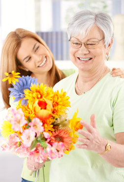 Elderly woman and daughter smiling happily