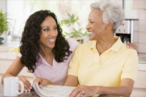 lady and old woman smiling at each other